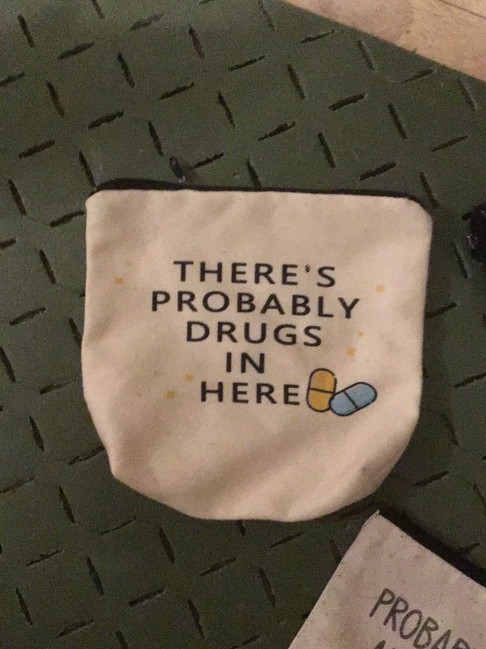 Cream colored cosmetic bag  with Blue and Yellow Pill Graphic drugs in here